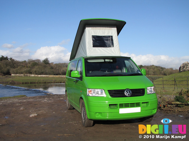 SX12383 Our green VW T5 campervan with popup roof up at Ogmore Castle